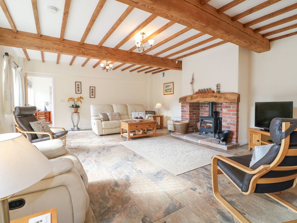 A living room with a sofa and fireplace at The Dairy in Eastwood