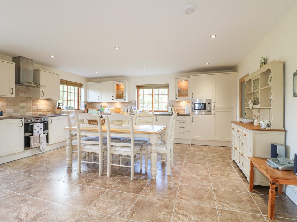 A kitchen with a table and chairs at The Dairy in Eastwood