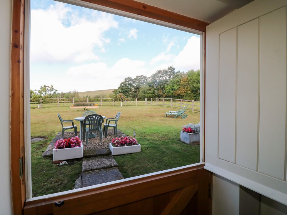 A view of a garden with table and chairs seen through a door at The Dairy Eastwood