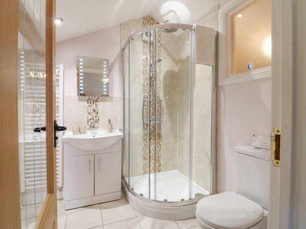 A bathroom with a shower, sink, and toilet at The Dairy Eastwood