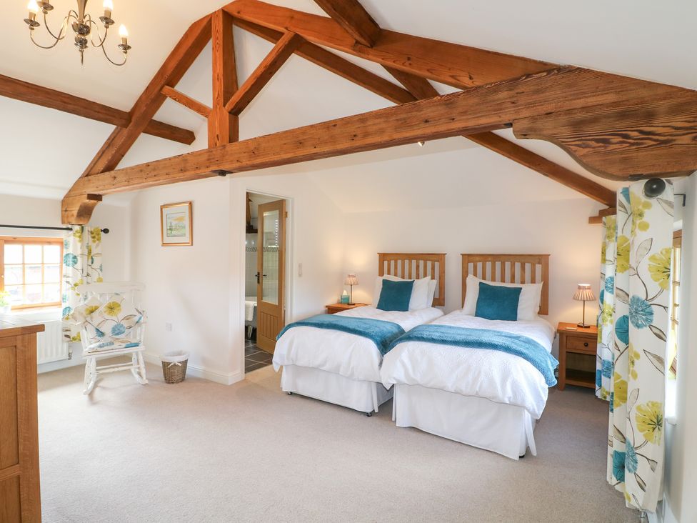 A bedroom with two beds and a nightstand at The Dairy in Eastwood