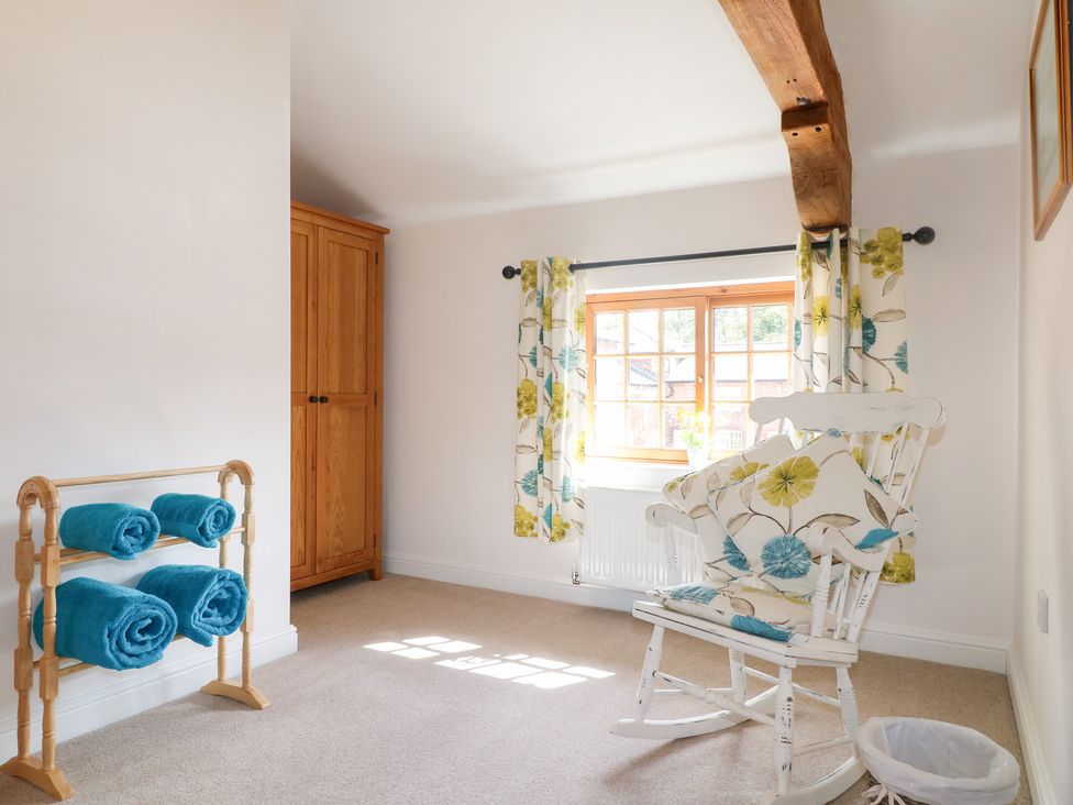 A sitting room with a rocking chair and towels on display at The Dairy in Eastwood