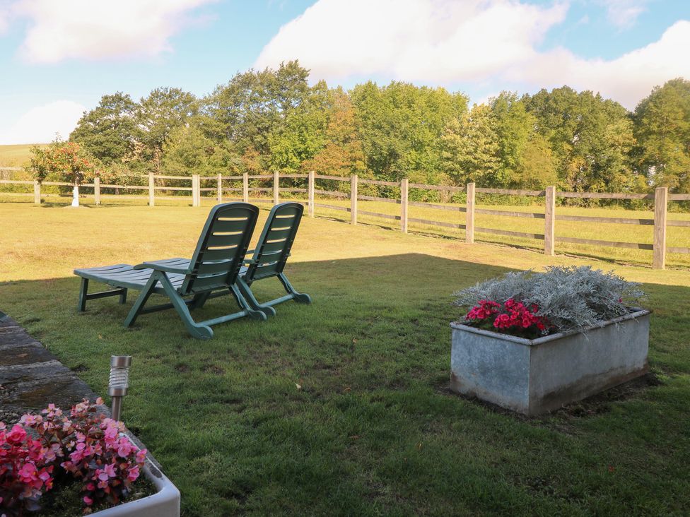 A garden with lawn chairs and flower boxes at The Dairy Eastwood