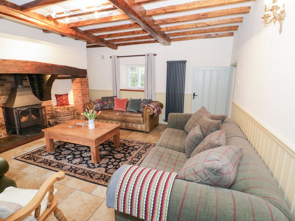 A living room with a fireplace and sofa at Town Mill in Bewdley