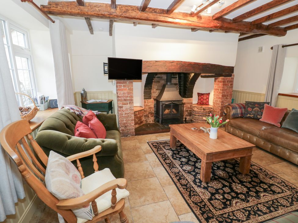 A living room with sofas and a fireplace at Town Mill in Bewdley