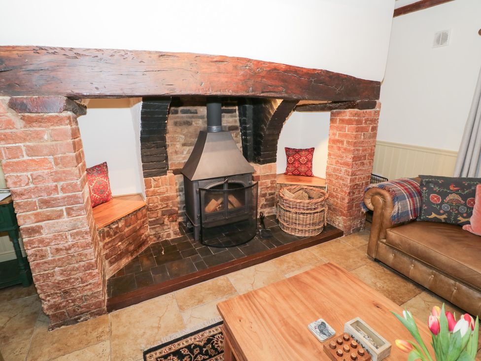 A living room with a fireplace and sofa at Town Mill in Bewdley