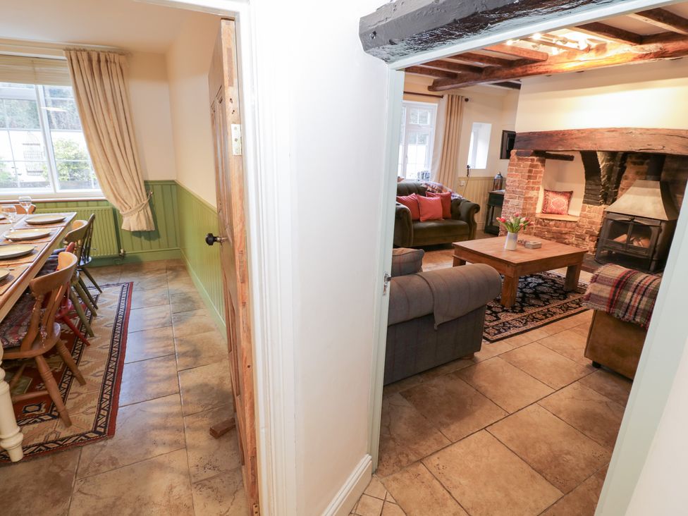 A dining room with a table and chairs visible from a hallway at Town Mill Bewdley