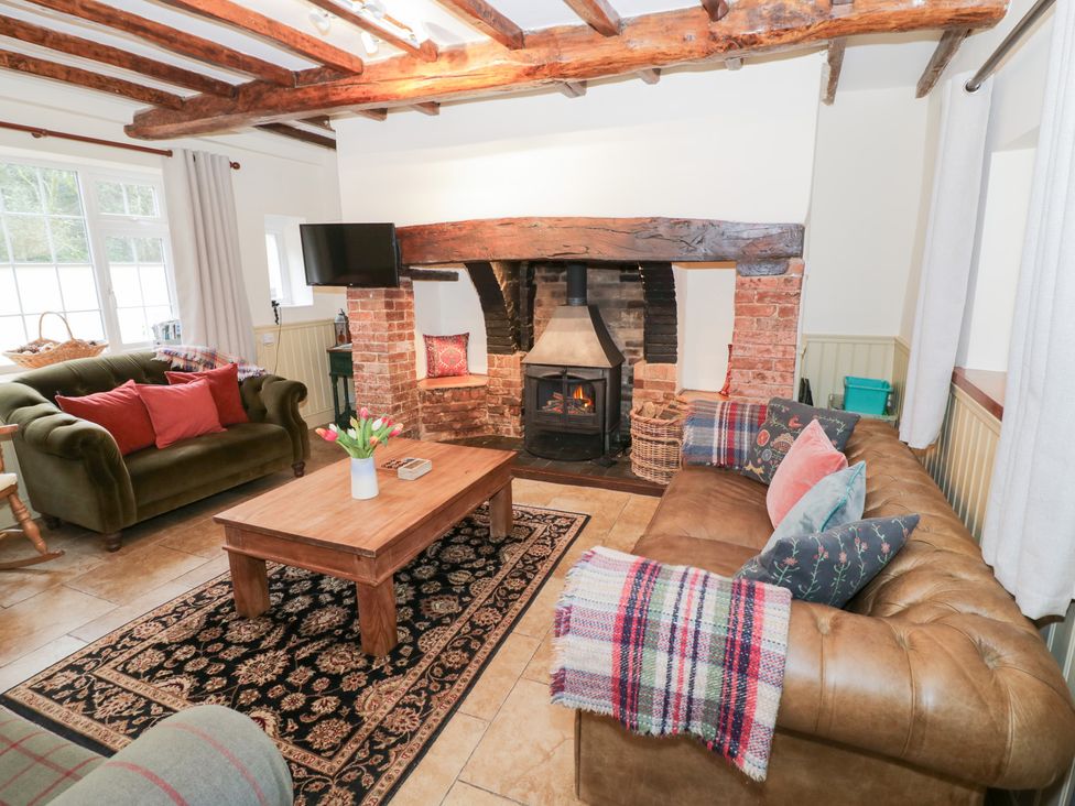 A living room with a fireplace and seating area at Town Mill in Bewdley