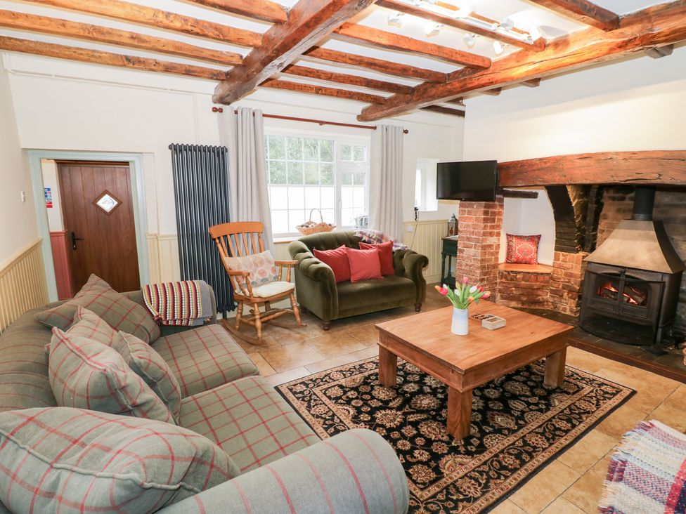 A living room with a sofa, armchair and fireplace at Town Mill in Bewdley