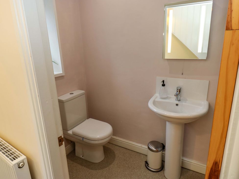 A bathroom with a toilet and sink at Maria Cottage in Haworth