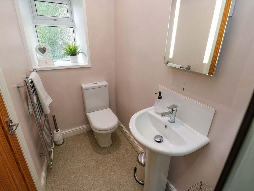 A bathroom with a sink and toilet at Maria Cottage in Haworth