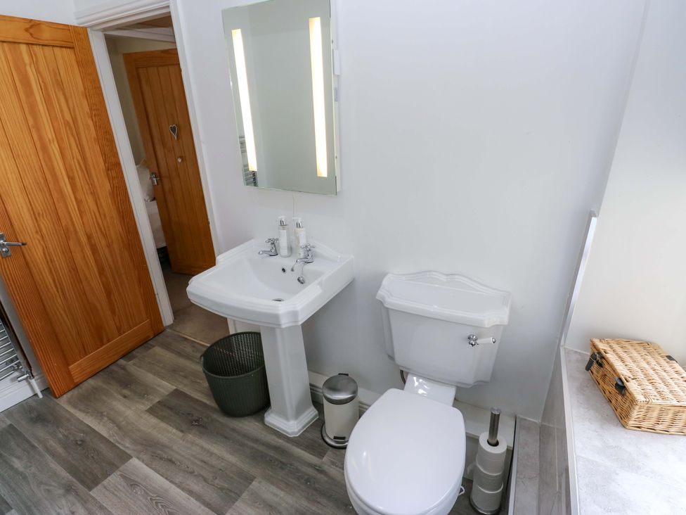 A bathroom with a sink and toilet at Maria Cottage in Haworth
