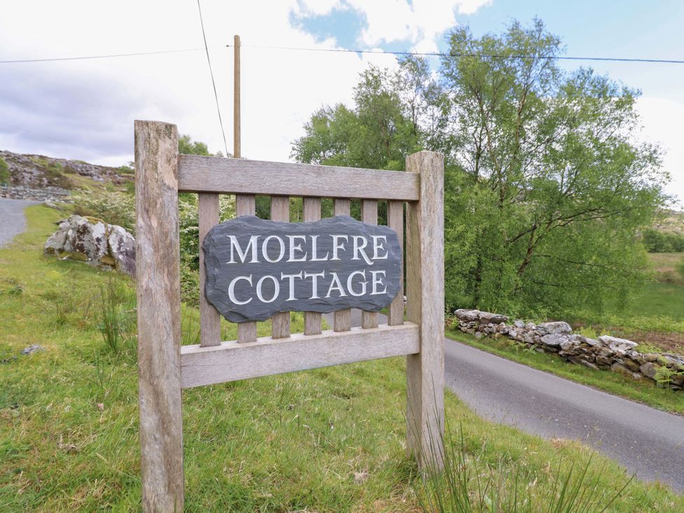 A sign reading Moelfre Cottage on the road in Llanbedr