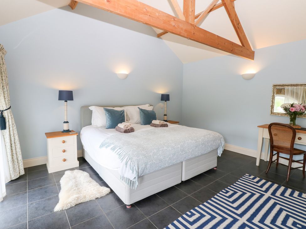 A bedroom with a bed and nightstands at Gallow Law Cottage Bellingham