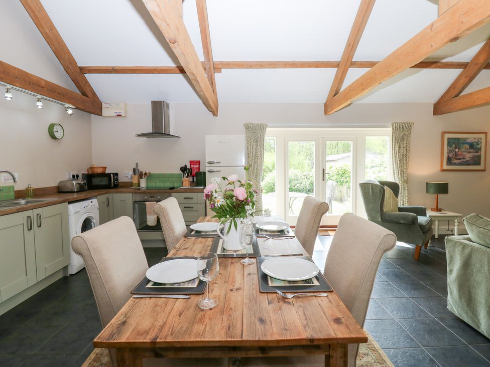 A kitchen with a dining table set for four at Shepherds Burn Cottage in Bellingham
