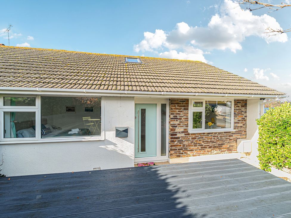 An exterior view of a house with a deck at Sunset View in Porth