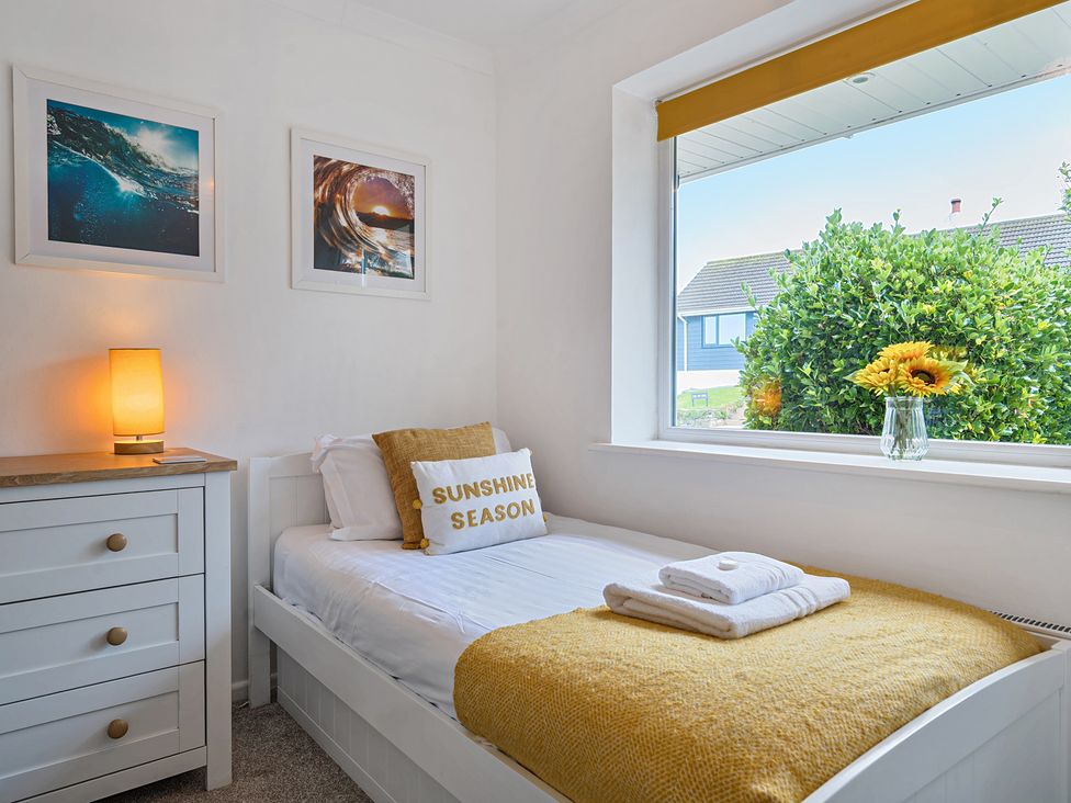A bedroom with a bed and a chest of drawers at Sunset View in Porth