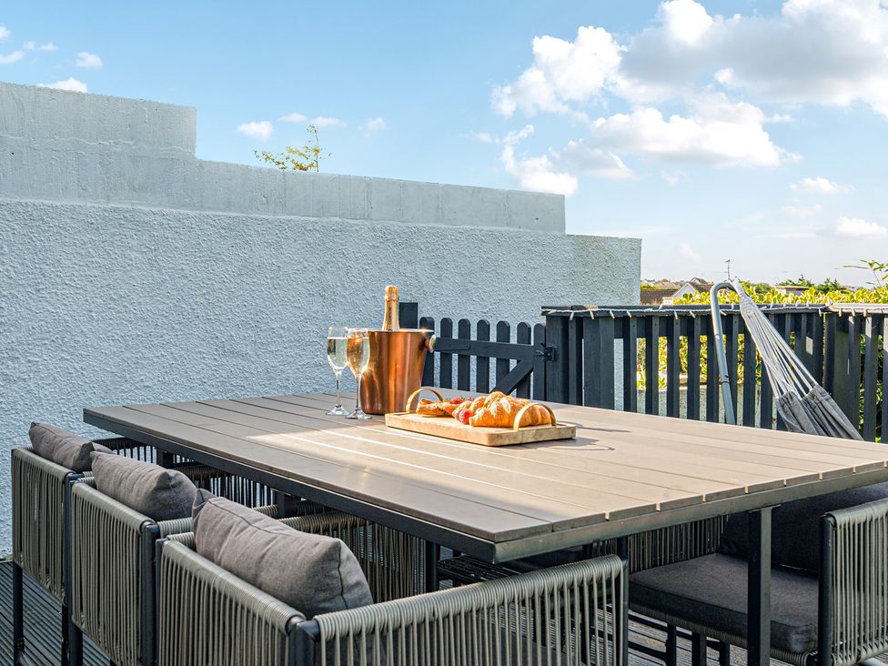 An outdoor dining area with a table and chairs at Sunset View in Porth