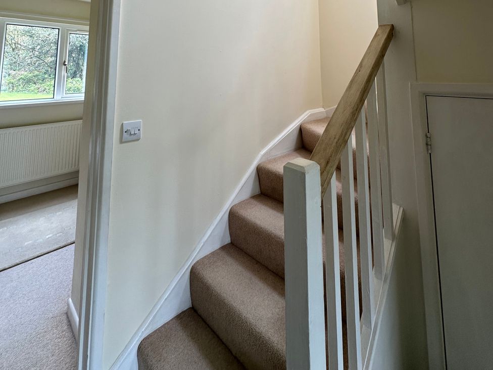 A staircase with handrail and window at Lodge 22, Bodmin Holiday Park, Cornwall