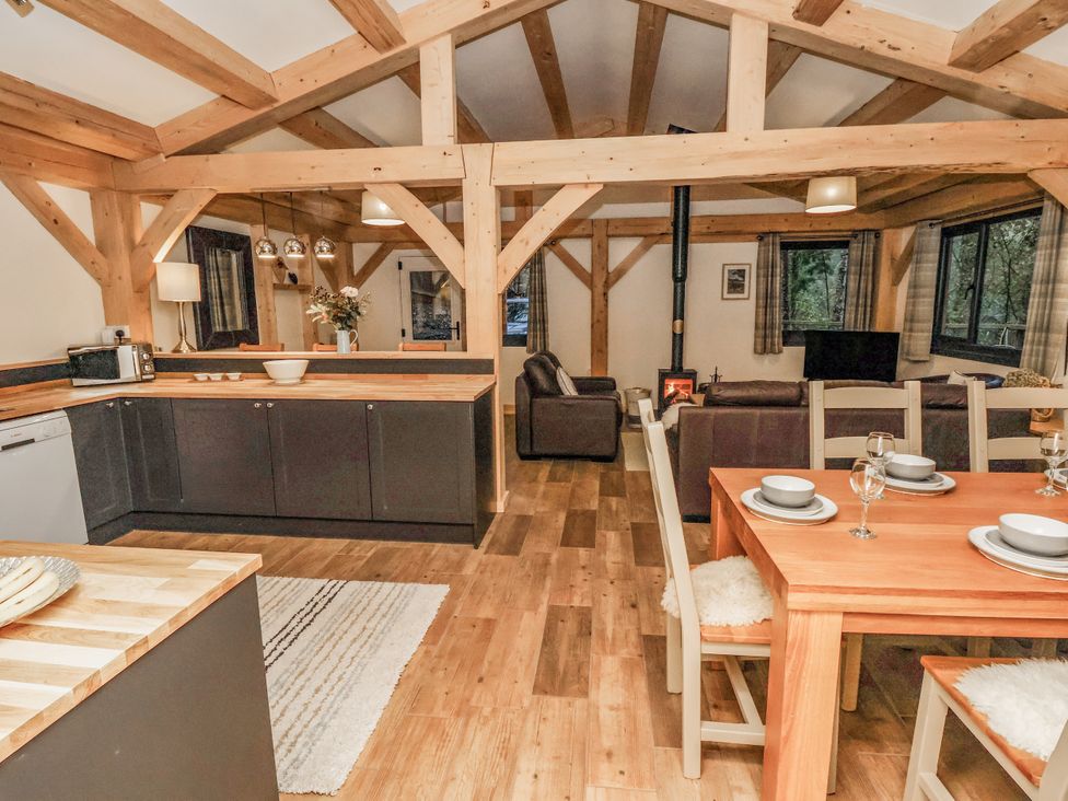 A kitchen and living room with dining area at Lady Bagots Cabin in Ruthin