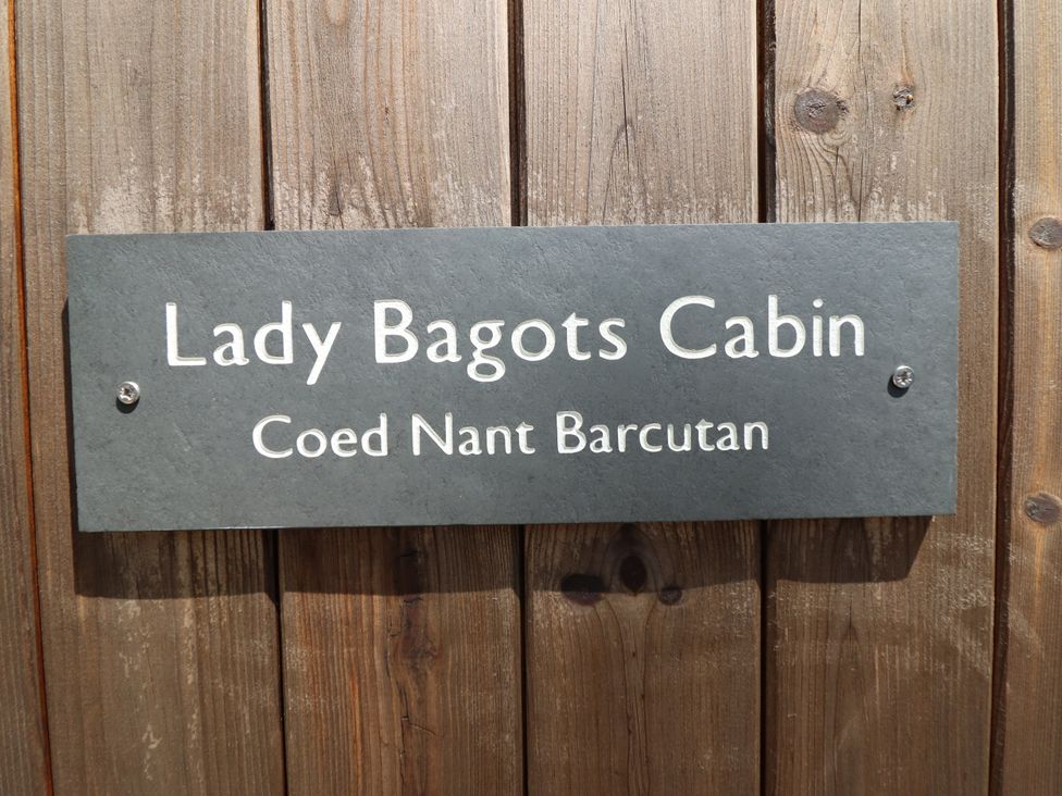 A sign displaying Lady Bagots Cabin at Coed Nant Barcutan
