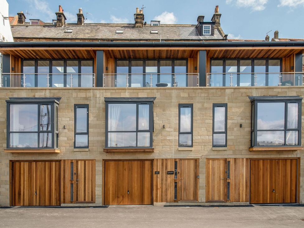 A modern building with large windows and wooden doors at Harbour Sunset in 