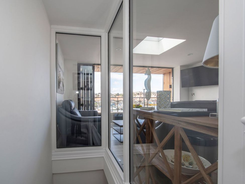 A living room with a sofa and a table at Harbour Sunset