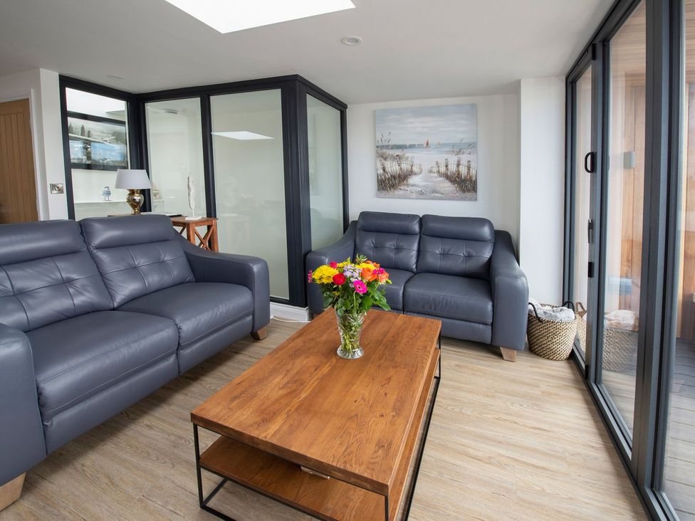 A living room with a sofa and coffee table at Harbour Sunset in 