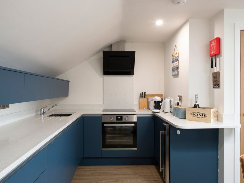 A kitchen with cabinets, stove, oven, and appliances at Harbour Sunset