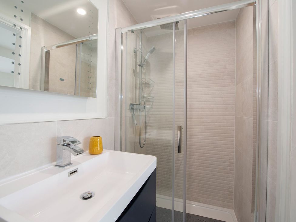 A bathroom with a shower and sink at Harbour Sunset
