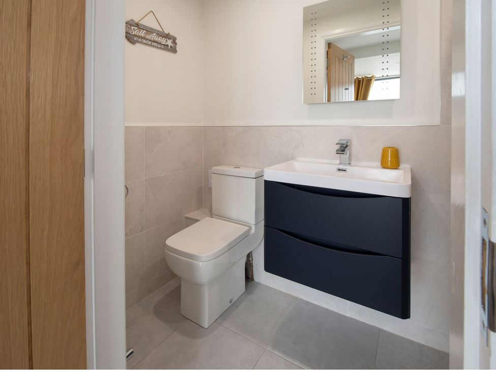A bathroom with a toilet and sink at Harbour Sunset