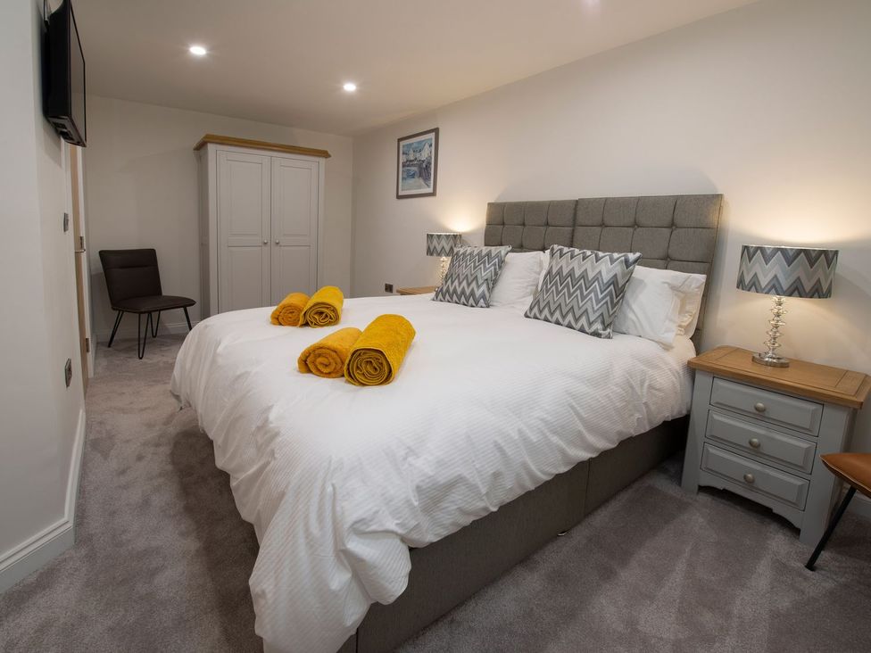 A bedroom with a double bed and wardrobe at Harbour Sunset