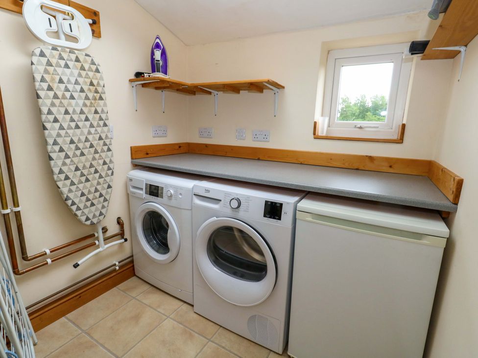 A laundry room with washing machine and tumble dryer at Mallows Byre in Yetminster