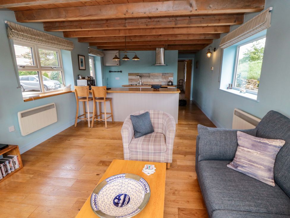 A living room with a sofa and armchair at Field Cottage in Staithes