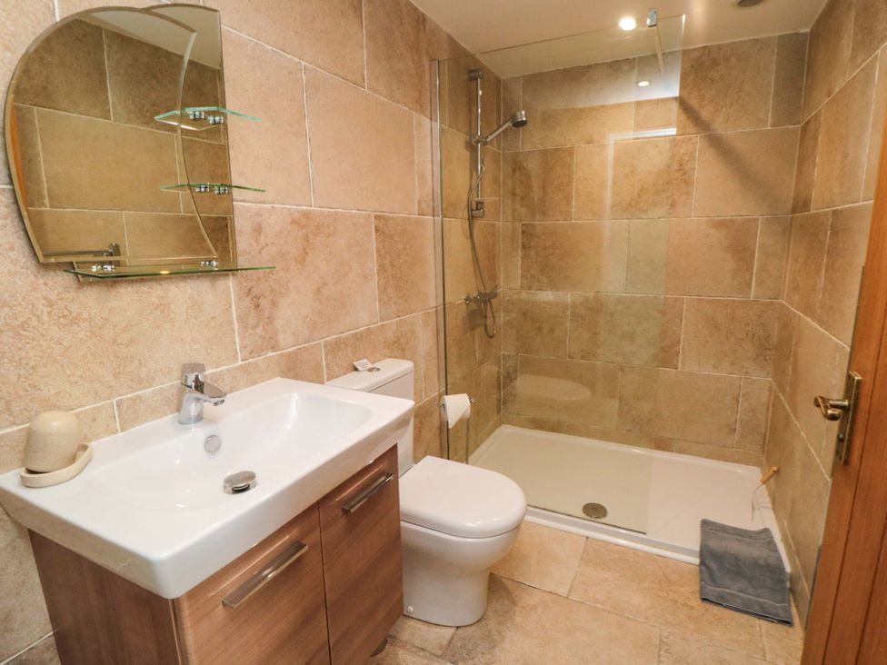 A bathroom with a sink and shower at Field Cottage in Staithes