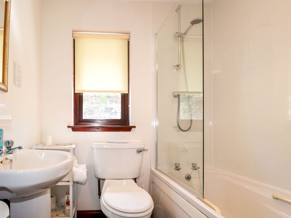 A bathroom with a sink, toilet, and shower at Glen Affric View at Hill House Cannich