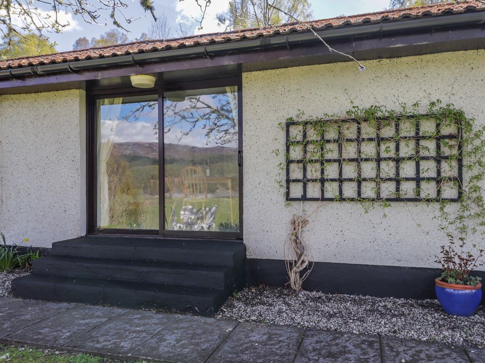 An outdoor area with a doorway and steps at Strath Glass View at Hill House Cannich