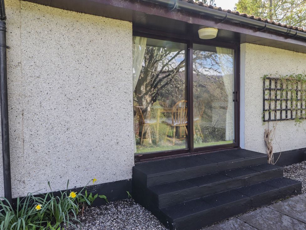 An entrance area with stairs and a window view at Strath Glass View at Hill House in Cannich