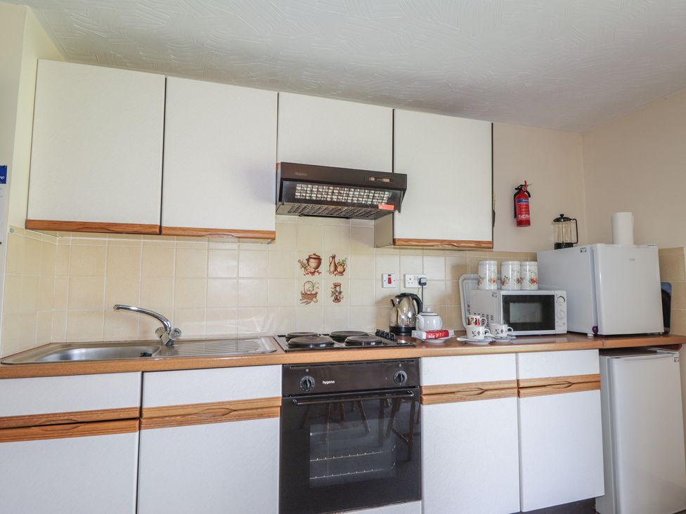 A kitchen with appliances and cabinets at Strath Glass View at Hill House Cannich
