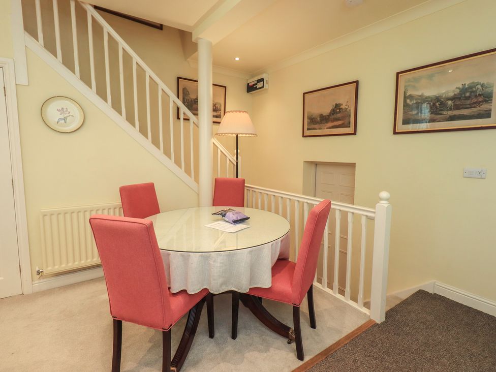 A dining room with a table and chairs at The Garden Rooms Lawkland in Austwick