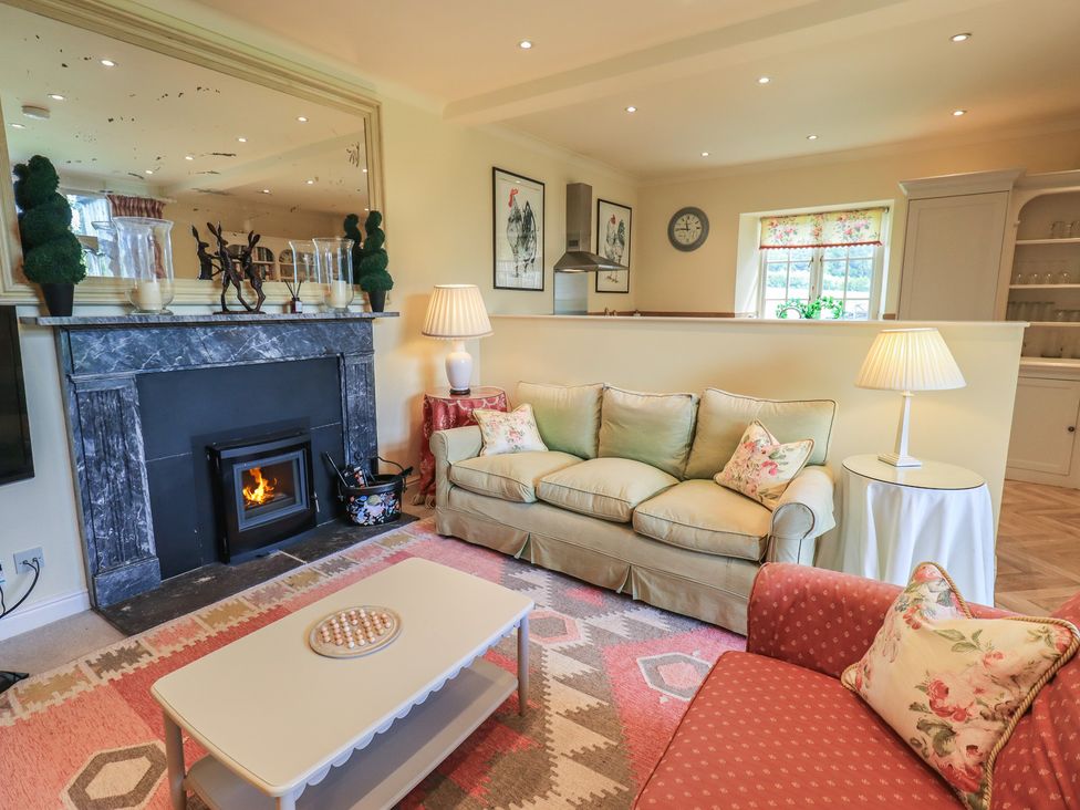 A living room with a sofa and armchair at The Garden Rooms Lawkland in Austwick