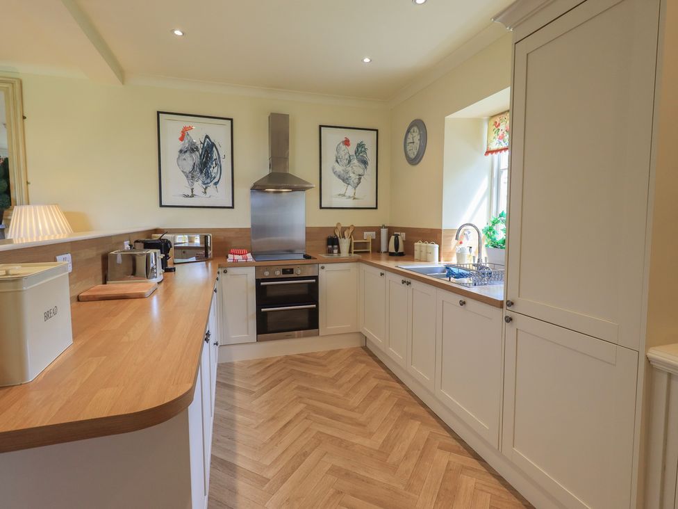 A kitchen with an oven and sink at The Garden Rooms Lawkland Austwick