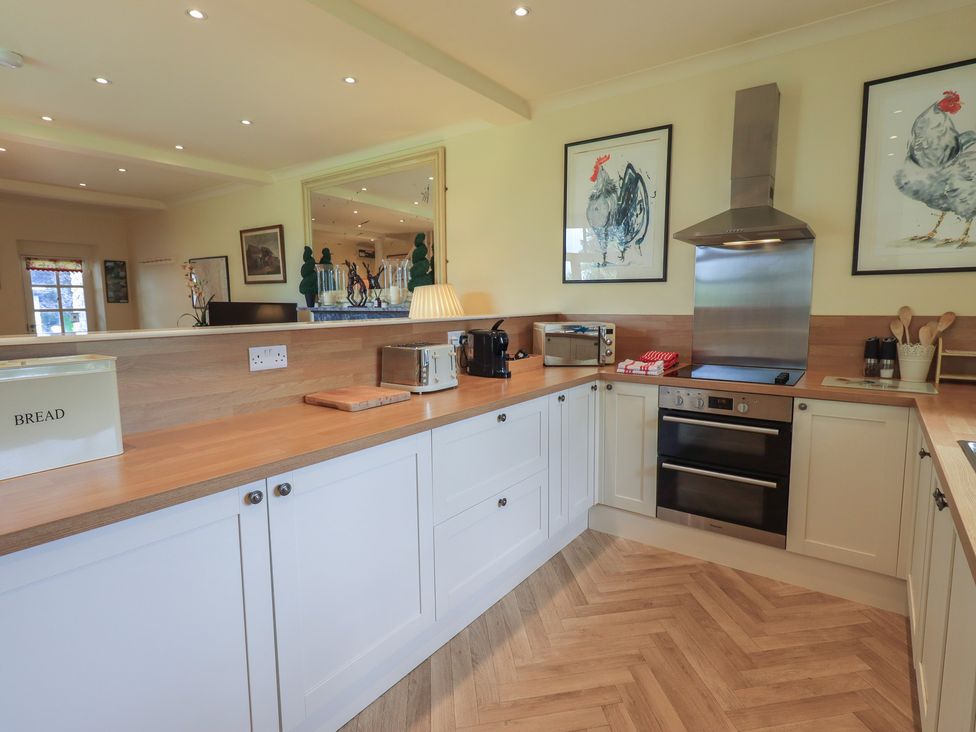 A kitchen with a counter and appliances at The Garden Rooms Lawkland Austwick