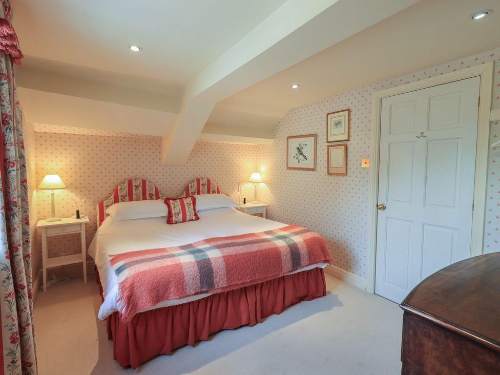 A bedroom with a bed and bedside tables at The Garden Rooms Lawkland Austwick