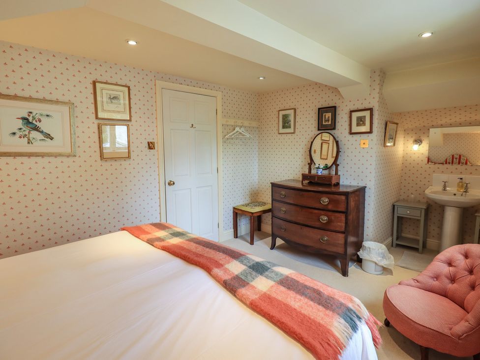A bedroom with a bed and a chest of drawers at The Garden Rooms Lawkland in Austwick