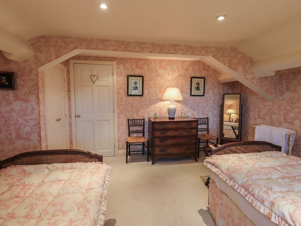 A bedroom with two beds and a dresser at The Garden Rooms Lawkland Austwick