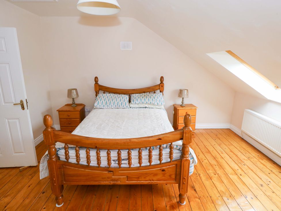 A bedroom with a bed and nightstands at Aisling in Foxford near Ballina, County Mayo