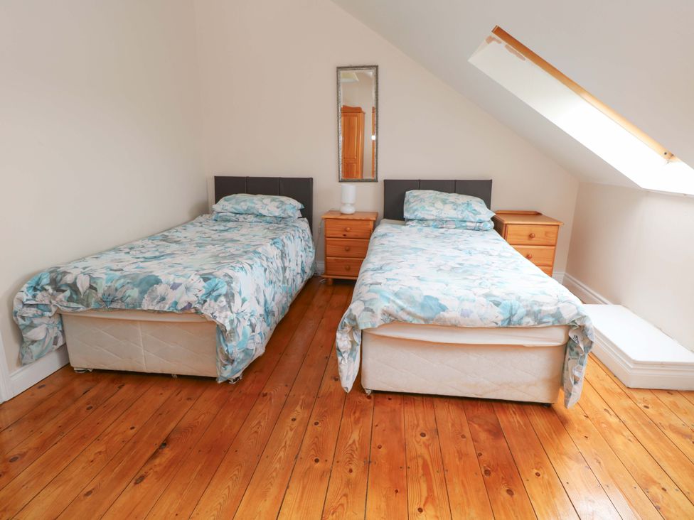 A bedroom with two beds separated by a bedside table at Aisling in Foxford near Ballina, County Mayo