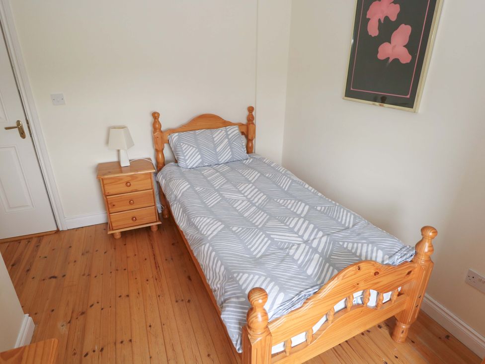 A bedroom with a single bed and bedside table at Aisling in Foxford near Ballina, County Mayo