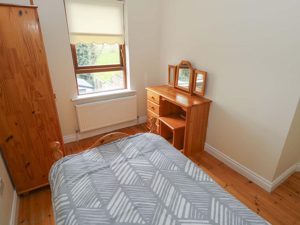 A bedroom with a bed and a dressing table at Aisling in Foxford near Ballina, County Mayo